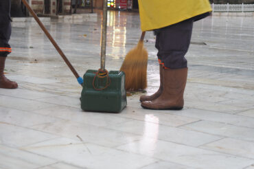 broom and dustpan to sweep the floor in a clean environment